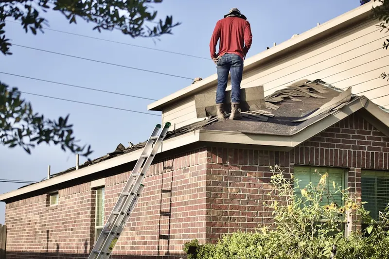 Professional roofer working on a residential roof in Del Paso Heights